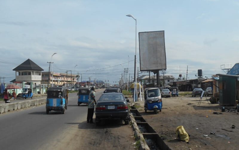Warri Portrait board Warri Along Effurun Road by Post Office Warri (AM)